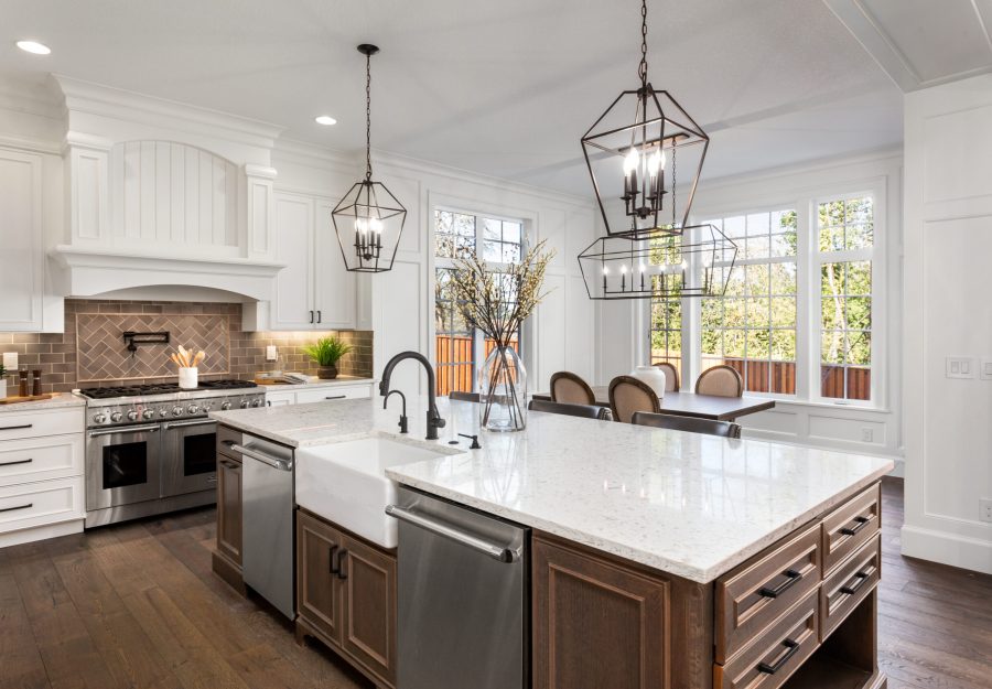 Beautiful kitchen in new traditional style luxury home, with quartz counters, hardwood floors, and stainless steel appliances